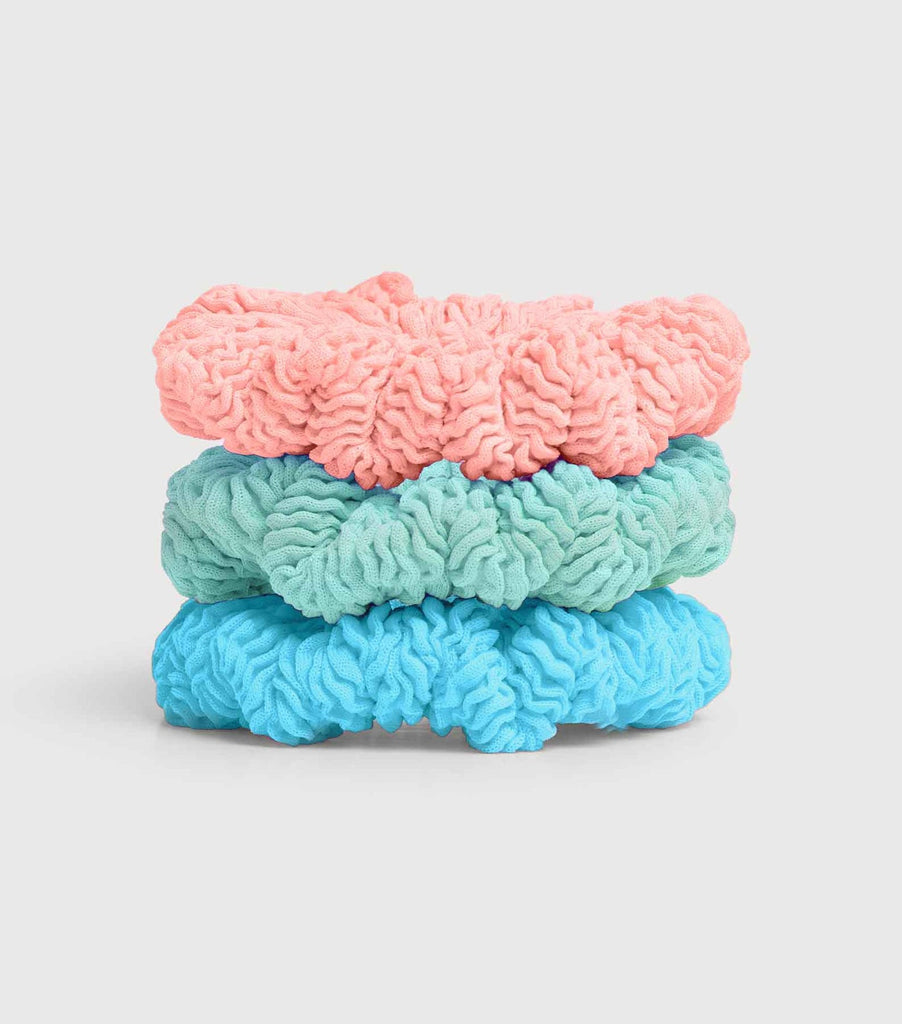 Product shot of the Hunza G Kids 3 park of scrunchies in aqua, peach and metallic mint