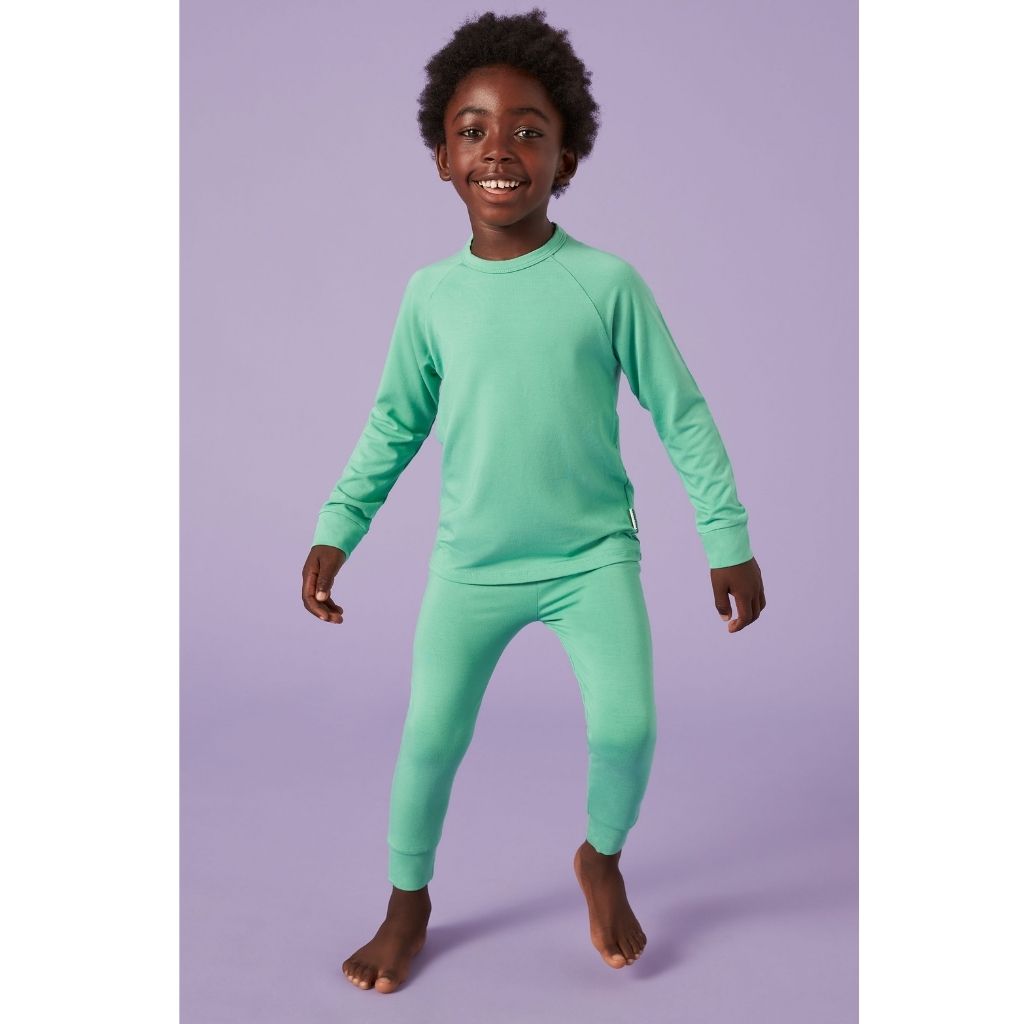 Little boy wearing Bamboo Base Layer thermals for Kids in Green from Roarsome