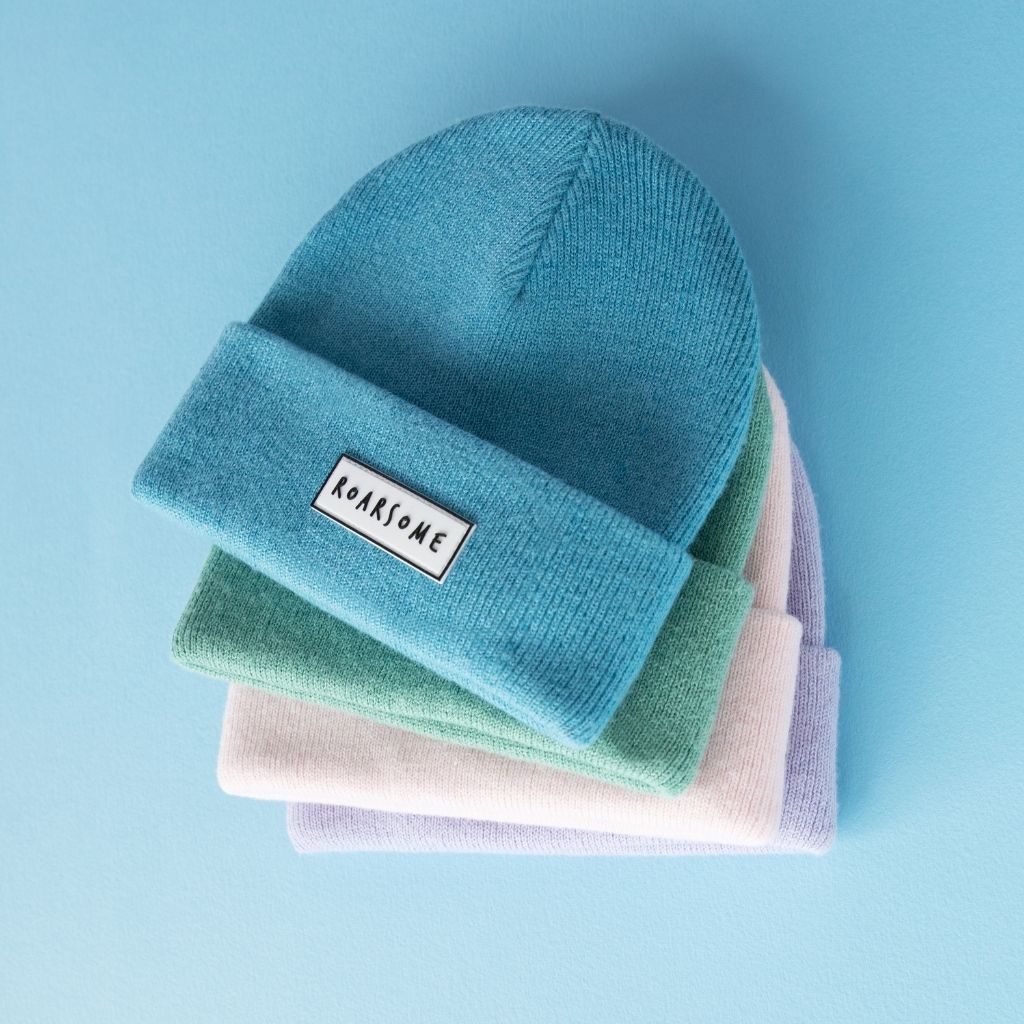 Stack of 4 beanie hats in blue, green, pink and purple from Roarsome