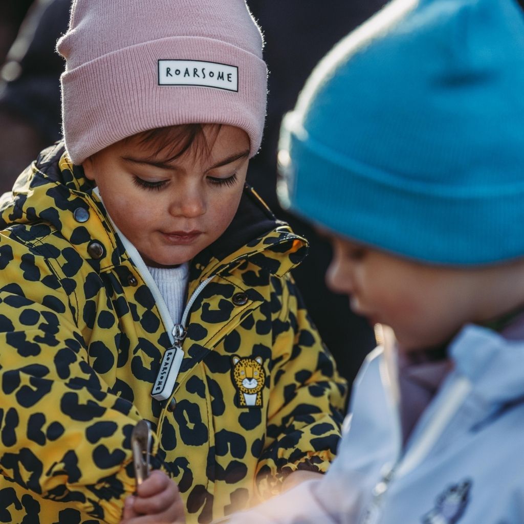 Children wearing their colourful beanie hats from Roarsome
