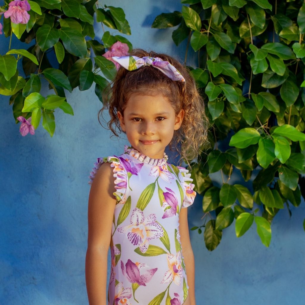 Little girl wearing the Orquideas Anggie Lila Alisson One piece Swimsuit for Girls from Colombian swim and resort wear brand Pepita & Me