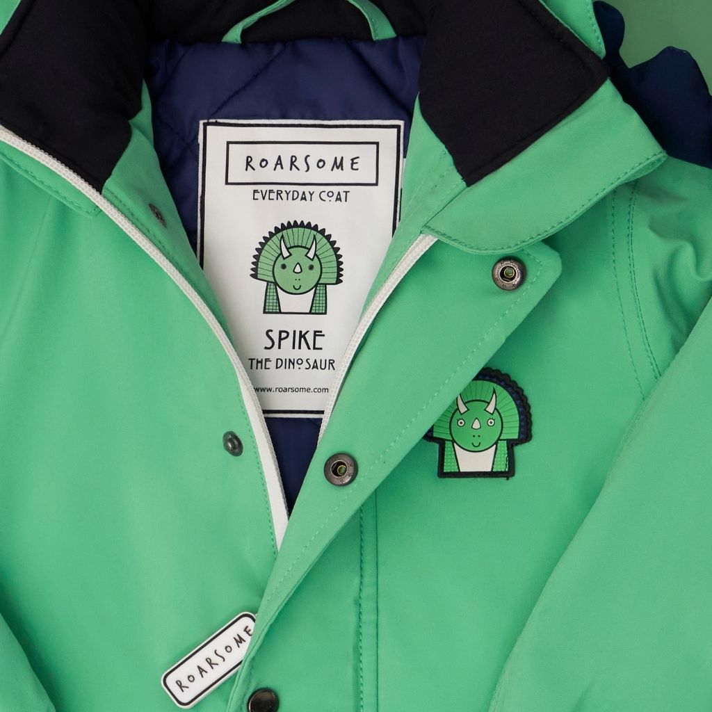 Close up of the Everyday Raincoat in Spike the Dinosaur Green from Roarsome