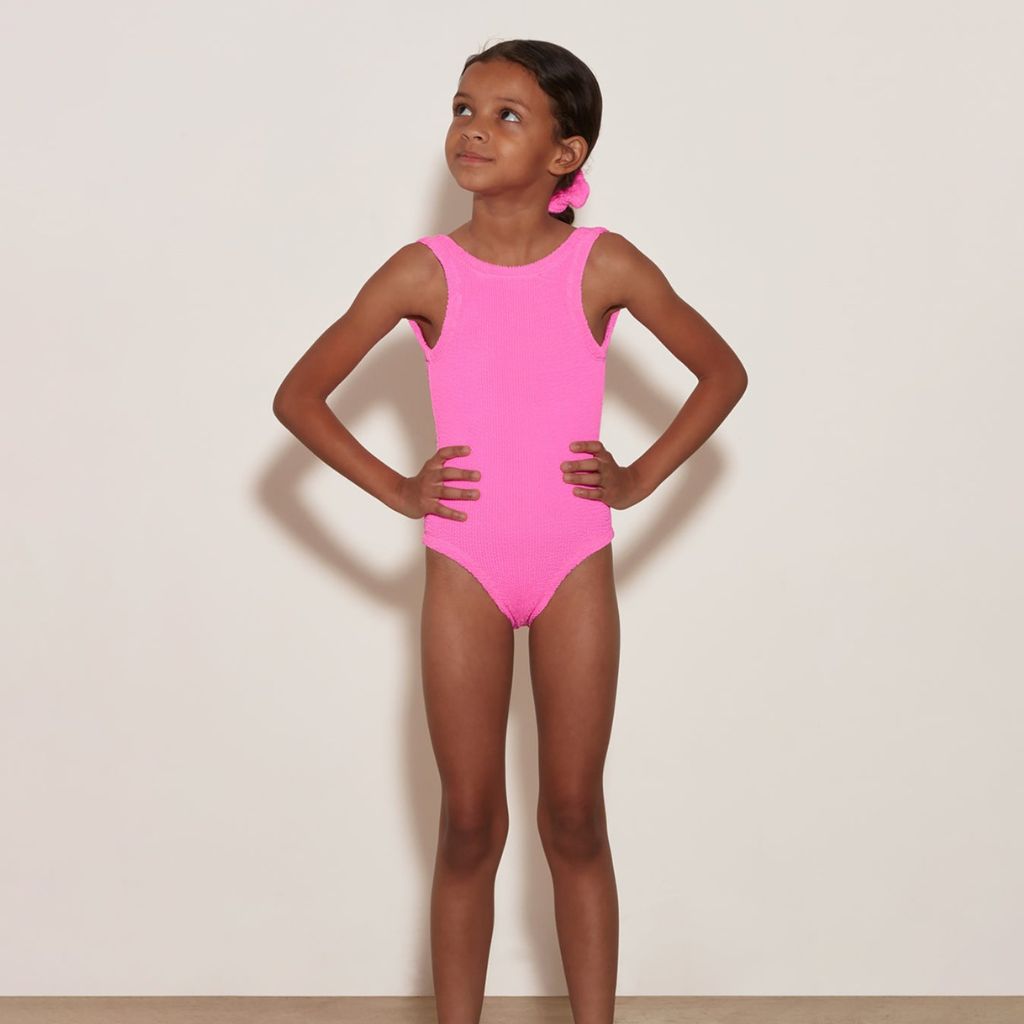 Little girl wearing the Hunza G Baby Classic Swimsuit in Bubblegum for girls aged 3 - 6 years