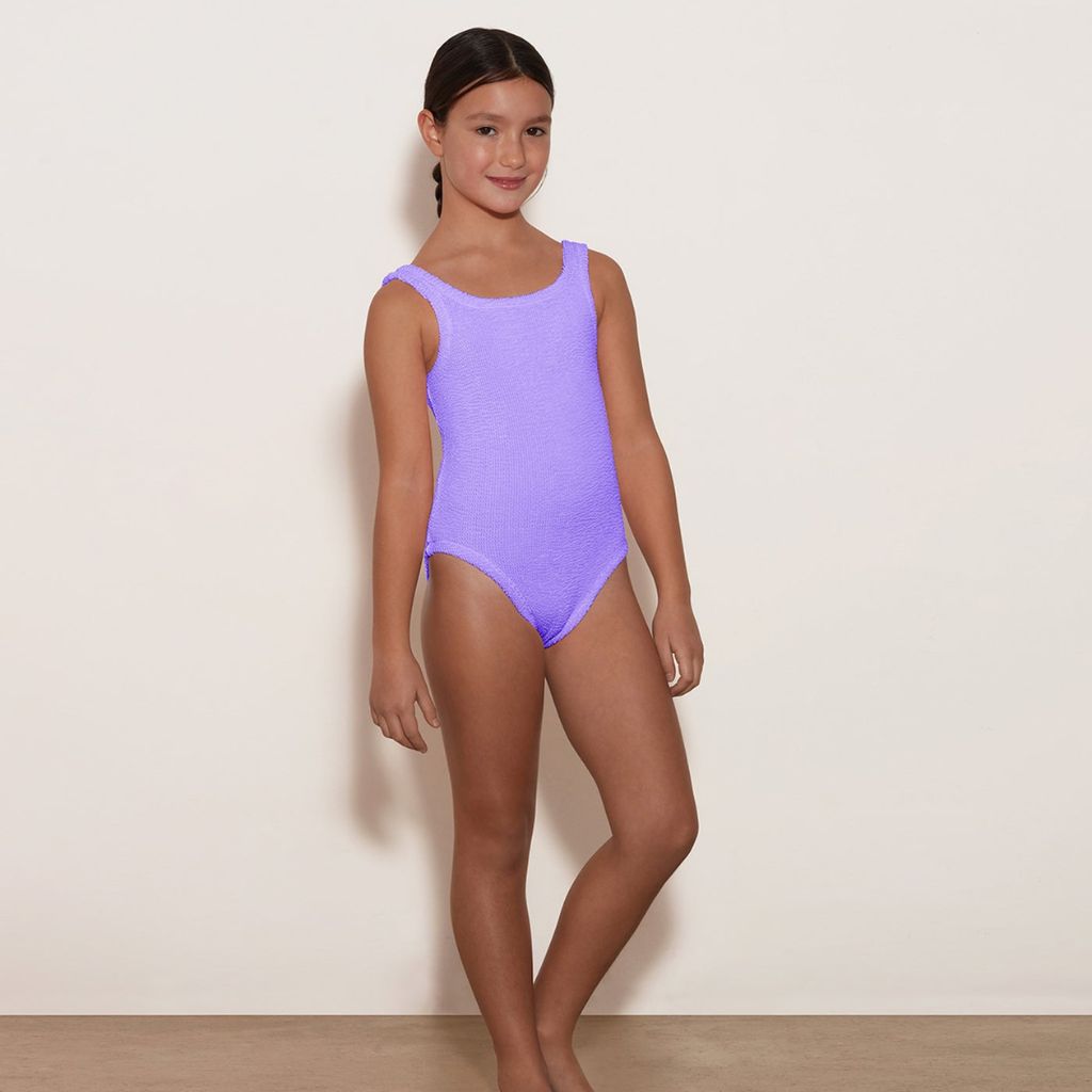 Image of a girl wearing the Hunza G Kids Classic Swimsuit in Lilac for girls aged 7 - 12 years
