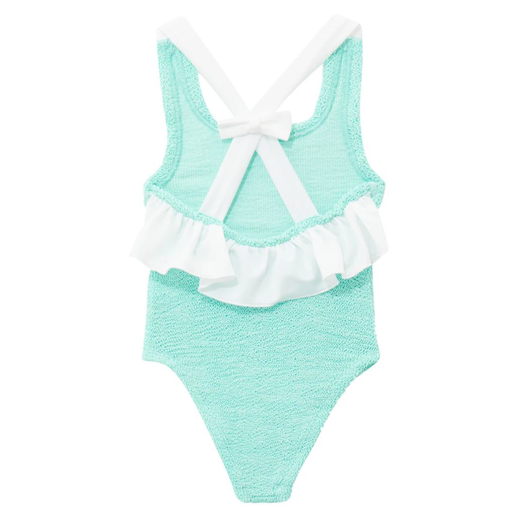 Close up of the Baby Lara swimsuit from Hunza G in a metallic mint colour way with a white bow on the back, for 3 - 6 year old girls.