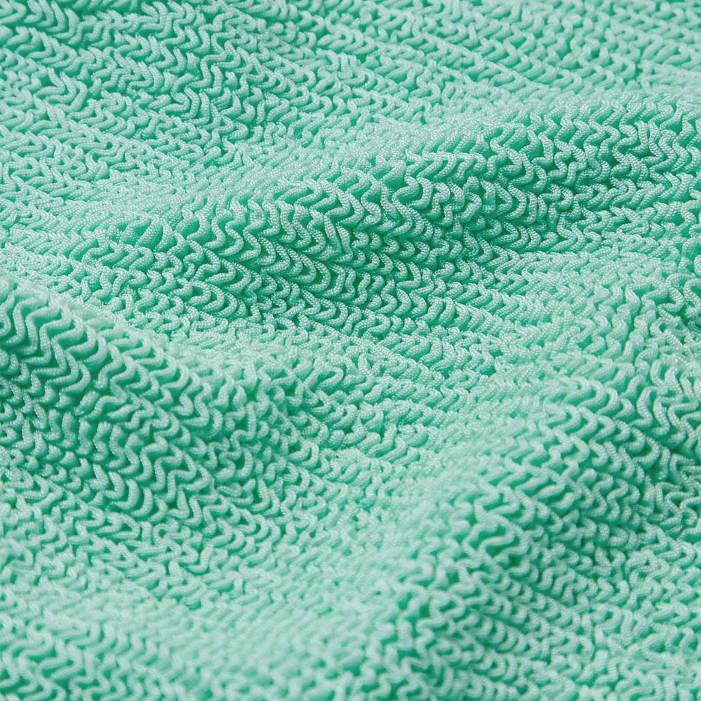 Close up of the Hunza G Baby Olive Bikini in Metallic Mint with white frill for girls aged 3 - 6 years