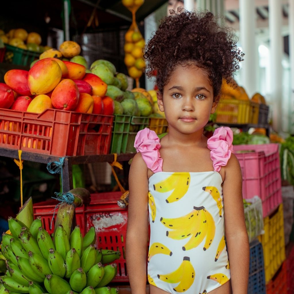 Little girl wearing the Banano Colombiano Bamba One Piece Swimsuit from Colombian swim and resort wear brand Pepita & Me