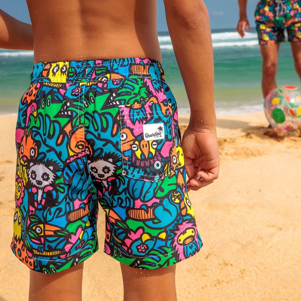 Little boy from the back wearing the Boardies Munday Jungle Kids Swim Shorts
