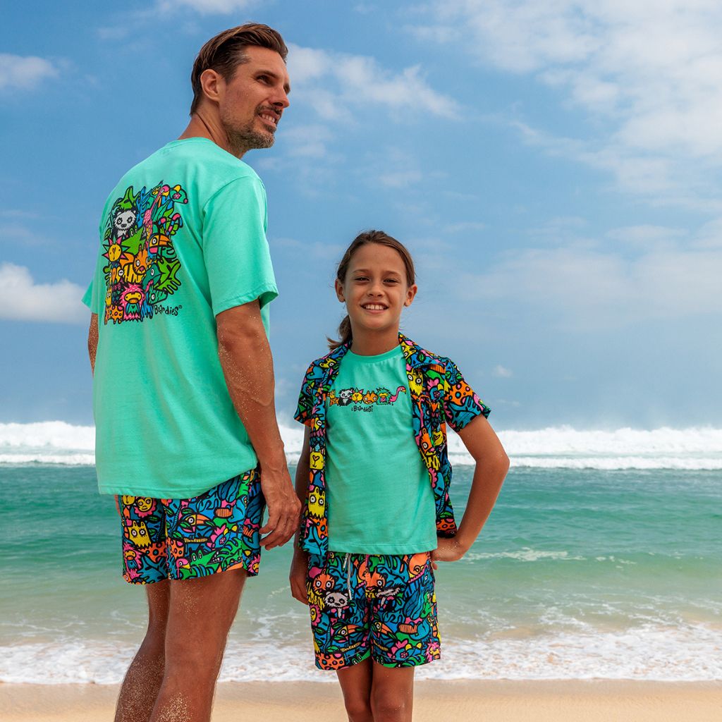 Image of father and son on the beach wearing the Boardies Munday Jungle T-Shirt in Green