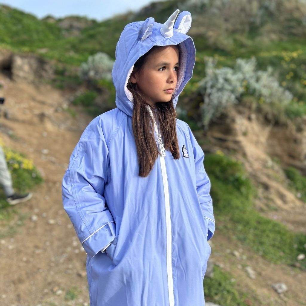 Little girl wearing the Sparkle the Unicorn Outdoor Changing Robe Dry Robe in purple from Roarsome