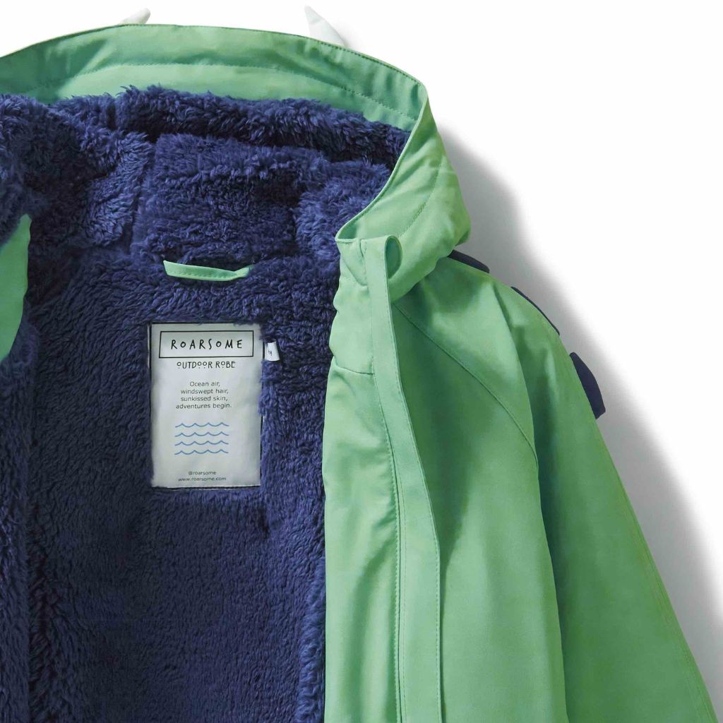 Close up of the Spike the Dinosaur Outdoor Changing Robe Dry Robe in green from Roarsome