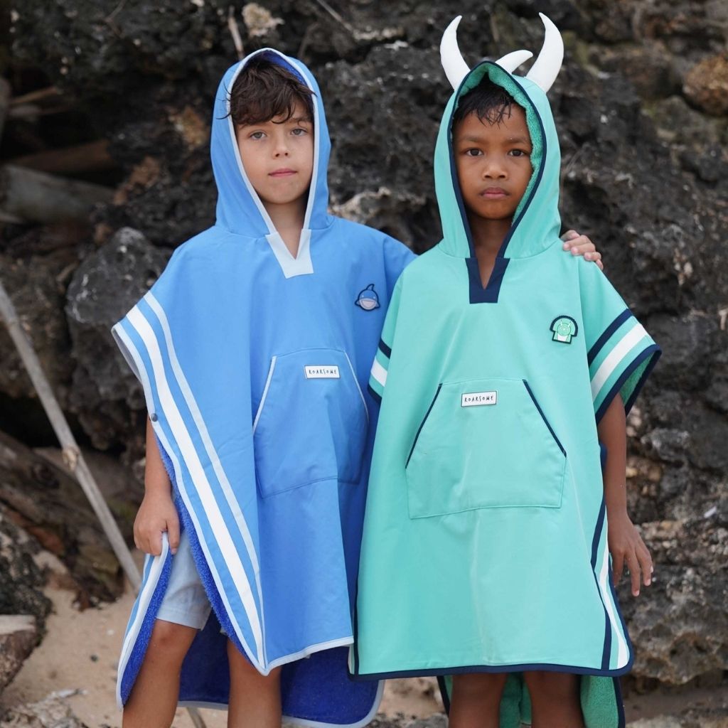 Boys on the beach wearing the Roarsome Poncho Towels 