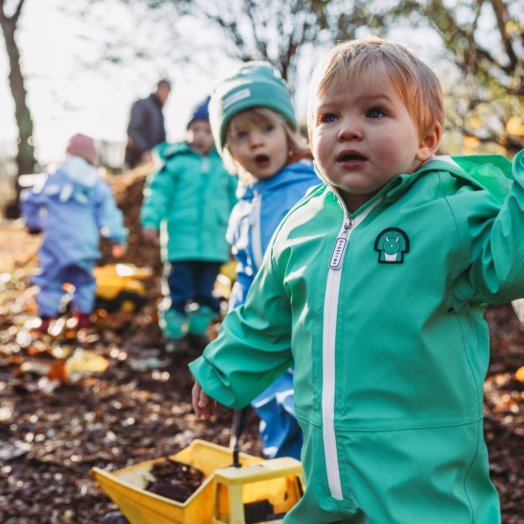 Little children wearing the Roarsome puddlesuits