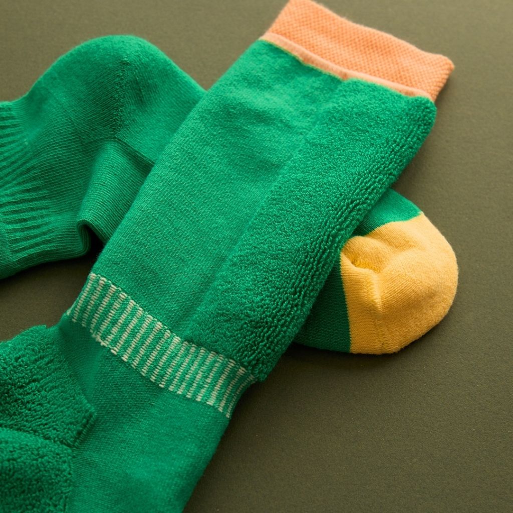 Close up of a Pair of green ski socks from global outdoor kids brand Roarsome