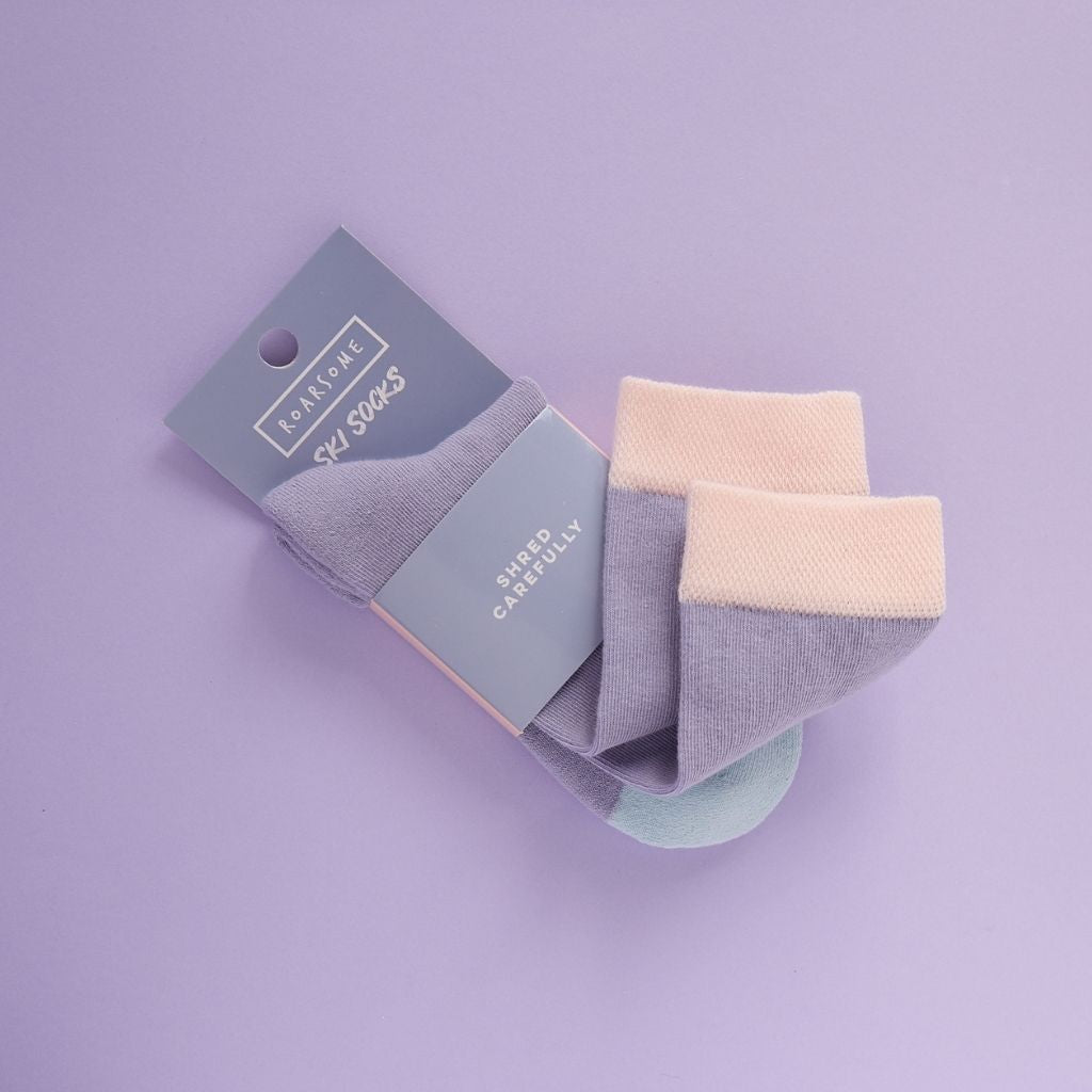 Packaging on a Pair of purple ski socks from global outdoor kids brand Roarsome