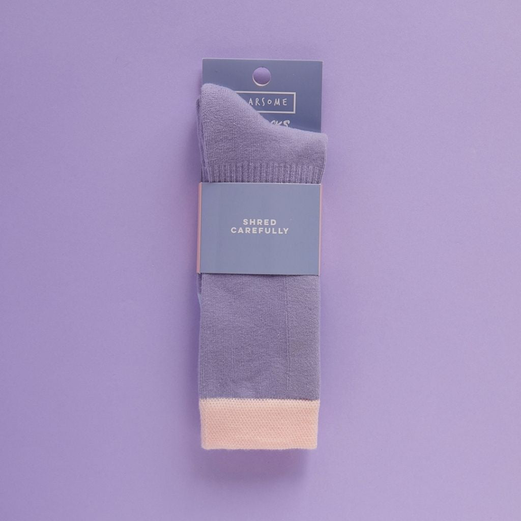 Packaging shot of a Pair of purple ski socks from global outdoor kids brand Roarsome